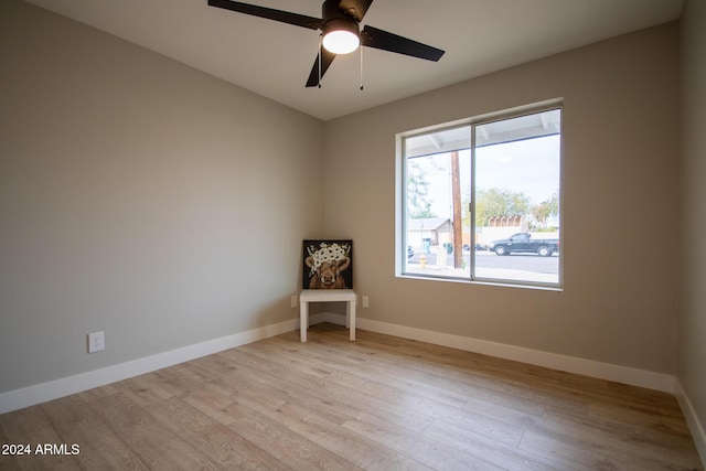 empty room featuring ceiling fan and light hardwood / wood-style floors