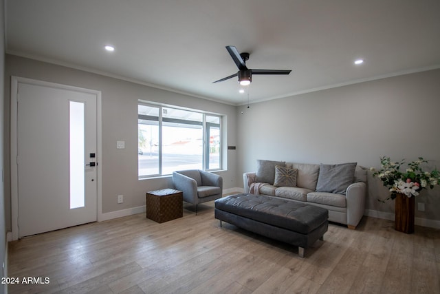 living room with ceiling fan, light hardwood / wood-style floors, and ornamental molding