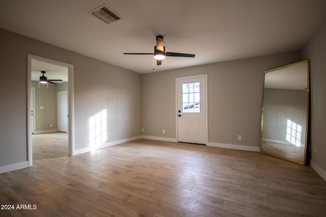 empty room featuring ceiling fan and light wood-type flooring