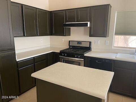 kitchen with sink, light tile patterned floors, exhaust hood, and stainless steel gas range