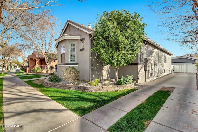 view of home's exterior featuring a yard and stucco siding