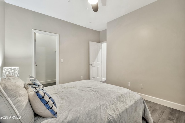 bedroom featuring a ceiling fan, baseboards, and wood finished floors