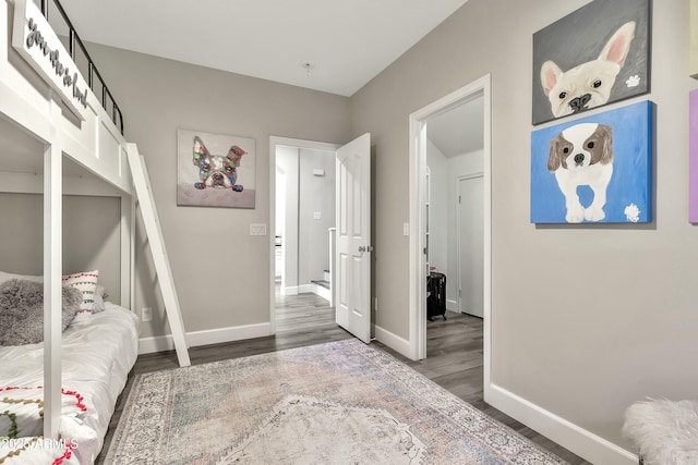 bedroom featuring baseboards and dark wood finished floors