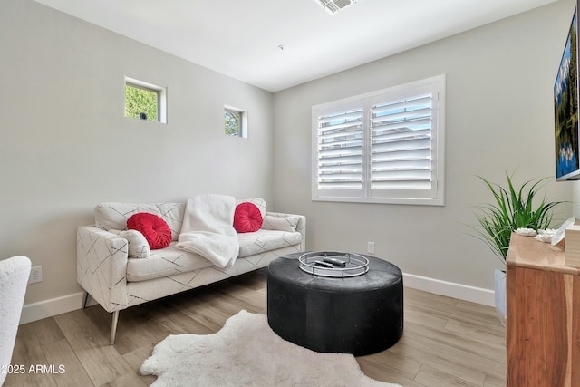 interior space with baseboards and light wood-style floors