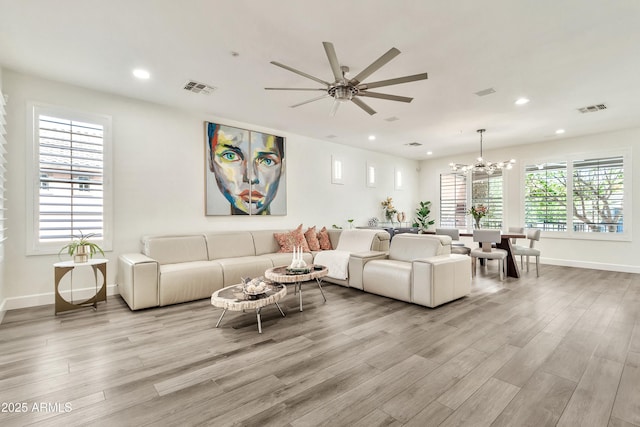 living room with light wood-style floors, recessed lighting, and visible vents