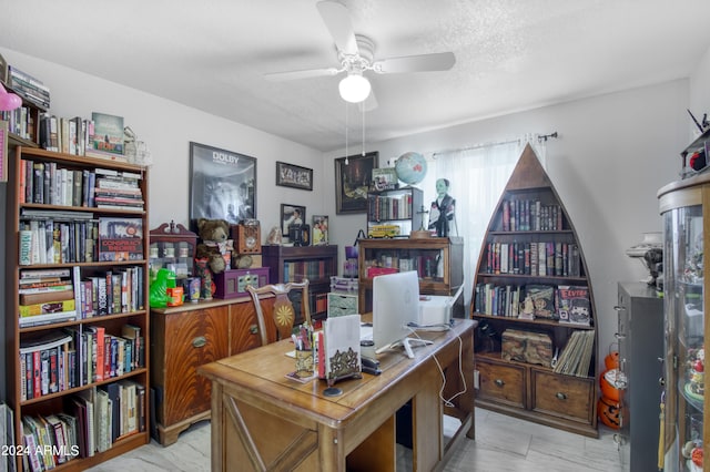 office area with ceiling fan and a textured ceiling