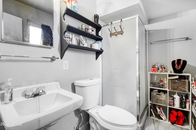 bathroom featuring an enclosed shower, toilet, and sink