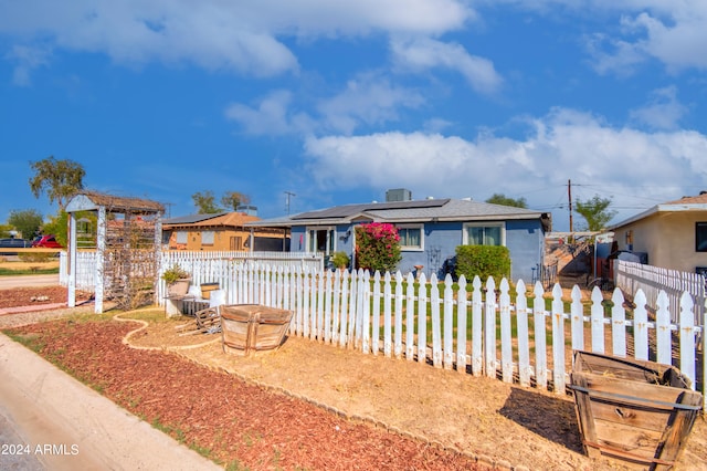 ranch-style house featuring solar panels