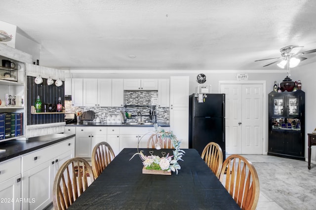 dining space featuring a textured ceiling, light tile patterned floors, and ceiling fan