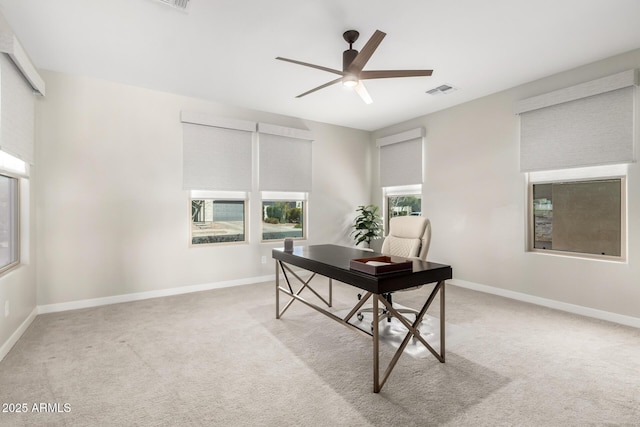 office area with a ceiling fan, carpet, and baseboards