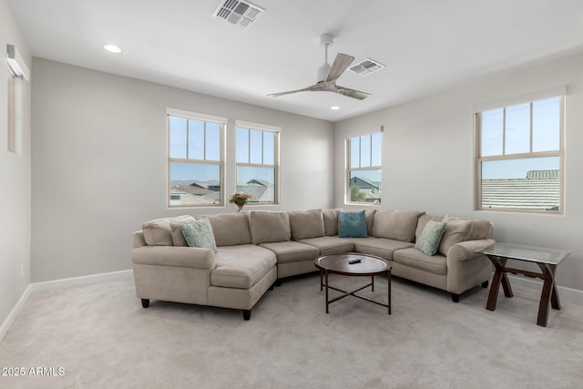 living room with light carpet, baseboards, and visible vents