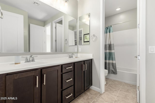 bathroom with double vanity, visible vents, toilet, tile patterned flooring, and a sink