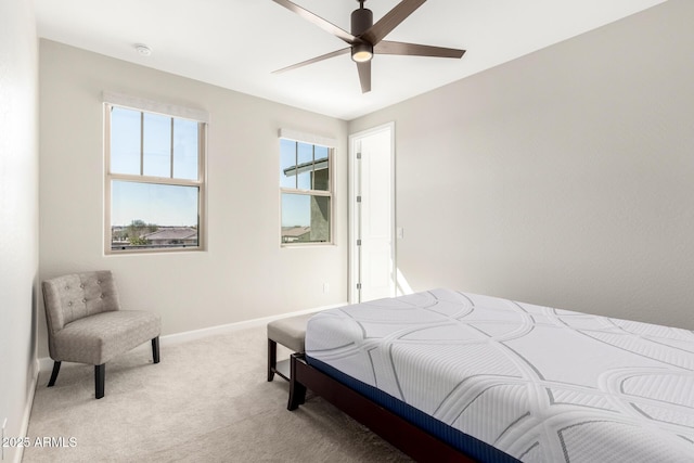 bedroom featuring baseboards, ceiling fan, and light colored carpet