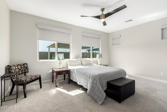 bedroom featuring light carpet, ceiling fan, visible vents, and baseboards