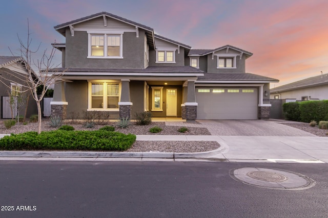 view of front of home with a garage, stone siding, decorative driveway, a porch, and stucco siding