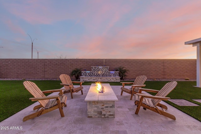 view of patio with an outdoor fire pit and fence