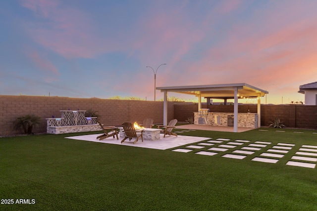 view of yard with a patio, an outdoor fire pit, area for grilling, and a fenced backyard