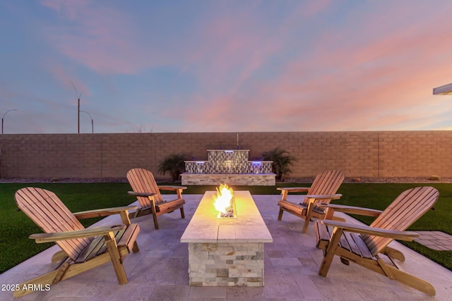 view of patio featuring an outdoor fire pit and a fenced backyard