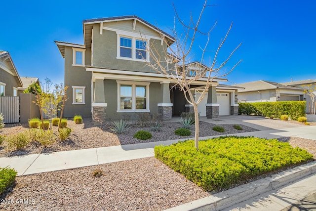 craftsman-style home with stone siding, fence, concrete driveway, and stucco siding