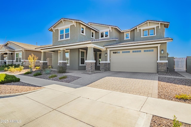 craftsman house featuring a porch, a garage, stone siding, decorative driveway, and stucco siding