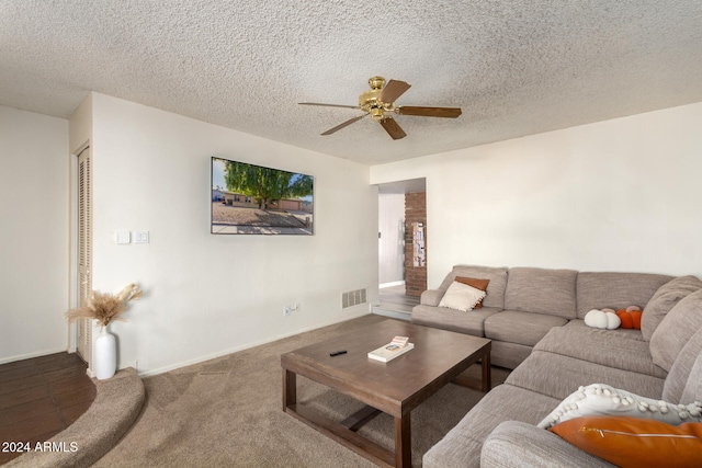 living room featuring carpet, a textured ceiling, and ceiling fan