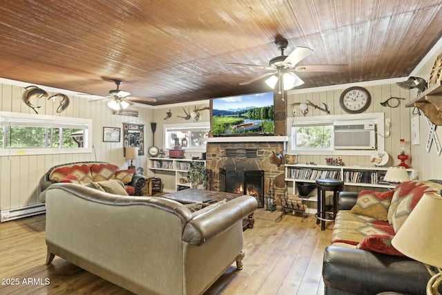 living room with wood ceiling, wooden walls, a fireplace, and light hardwood / wood-style floors