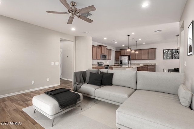 10307 E Tiburon Ave, Mesa, AZ 85212 - living room featuring wood finished floors, recessed lighting, a ceiling fan, and baseboards