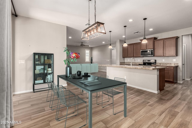10307 E Tiburon Ave, Mesa, AZ 85212 - kitchen featuring stainless steel appliances, a sink, recessed lighting, light wood-style floors, and light stone counters