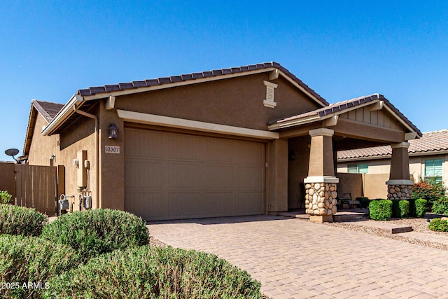 10307 E Tiburon Ave, Mesa, AZ 85212 - view of front of home featuring an attached garage, stucco siding, decorative driveway, and fence