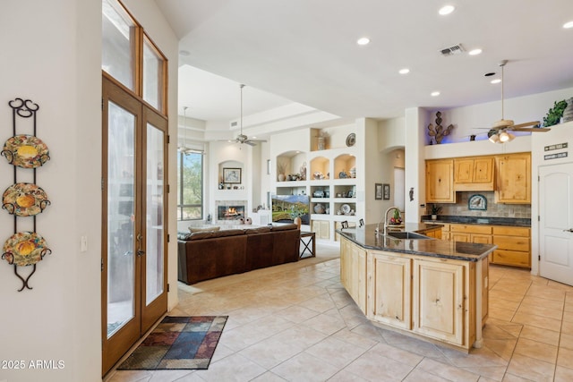 148 N La Barge Rd, Apache Junction, AZ 85119 - kitchen with a ceiling fan, light tile patterned floors, light brown cabinetry, a lit fireplace, and recessed lighting