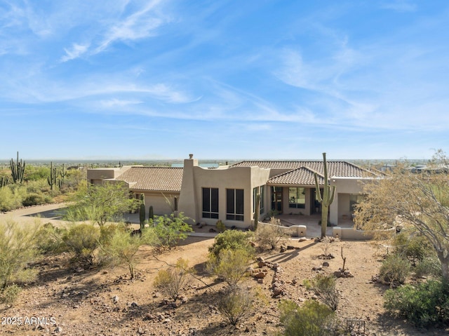 148 N La Barge Rd, Apache Junction, AZ 85119 - back of house featuring a tile roof, a chimney, stucco siding, and a patio