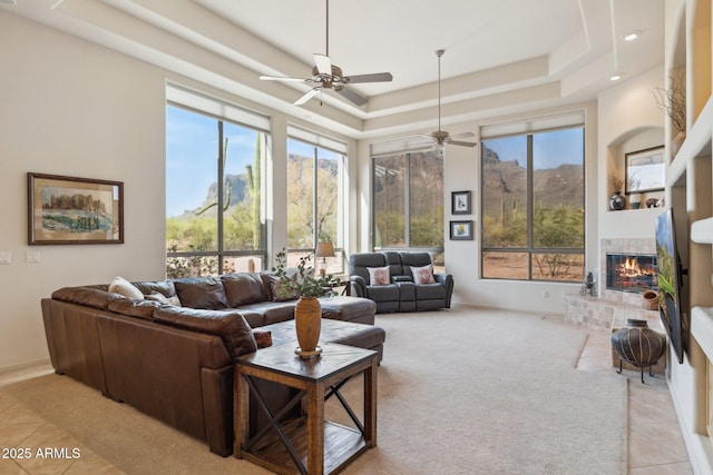148 N La Barge Rd, Apache Junction, AZ 85119 - living area featuring ceiling fan, a raised ceiling, a fireplace, healthy amount of natural light, and recessed lighting