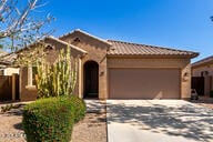 view of front facade with an attached garage, concrete driveway, stucco siding, and a tile roof