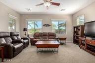 living room featuring a healthy amount of sunlight, ceiling fan, baseboards, and carpet floors