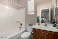 bathroom with toilet, tub / shower combination, and vanity