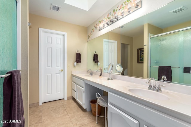 bathroom with tile patterned floors, vanity, and walk in shower