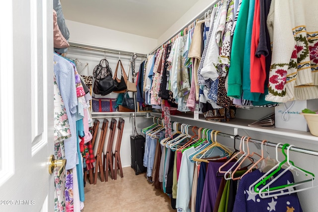 spacious closet with light tile patterned floors