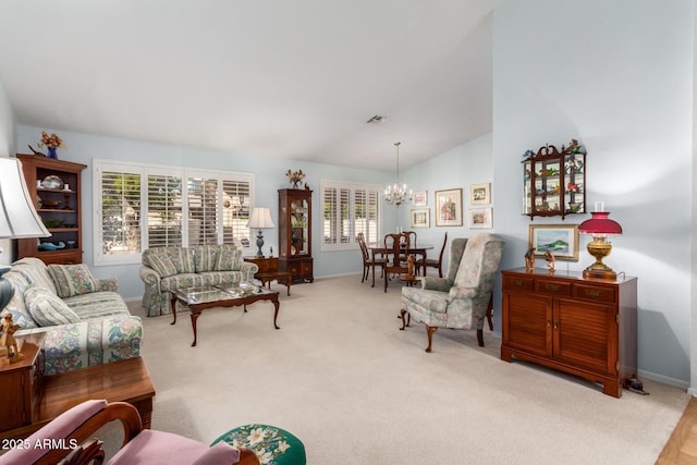 carpeted living room featuring a chandelier and lofted ceiling