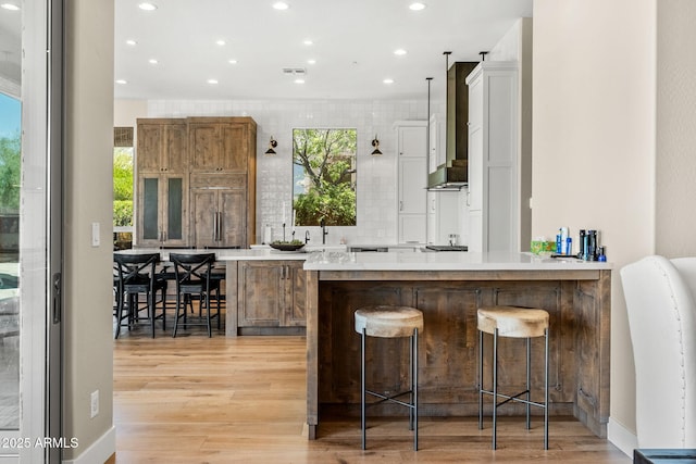 11324 E Diamond Cholla Dr, Scottsdale, AZ 85255 - bar area featuring light wood-style flooring, recessed lighting, decorative backsplash, and a sink