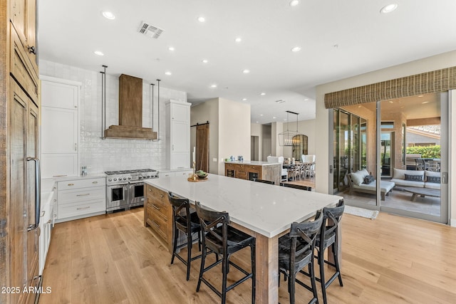 11324 E Diamond Cholla Dr, Scottsdale, AZ 85255 - kitchen with double oven range, a large island, premium range hood, recessed lighting, and light wood finished floors