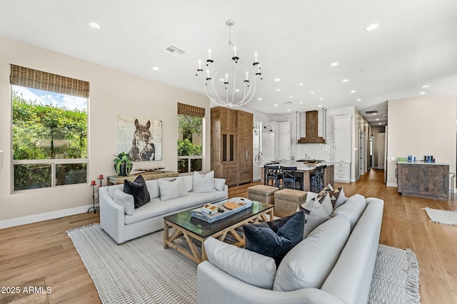 11324 E Diamond Cholla Dr, Scottsdale, AZ 85255 - living area with plenty of natural light, recessed lighting, a chandelier, baseboards, and light wood-style floors
