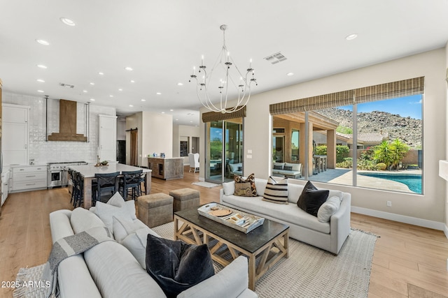 11324 E Diamond Cholla Dr, Scottsdale, AZ 85255 - living area featuring recessed lighting, light wood-style floors, a chandelier, and baseboards