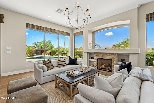 11324 E Diamond Cholla Dr, Scottsdale, AZ 85255 - living area with a chandelier, light wood-style floors, a fireplace, baseboards, and recessed lighting