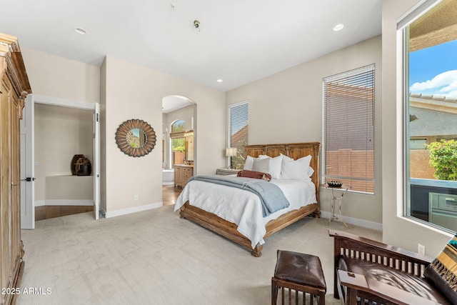 11324 E Diamond Cholla Dr, Scottsdale, AZ 85255 - bedroom with arched walkways, light colored carpet, baseboards, ensuite bath, and recessed lighting