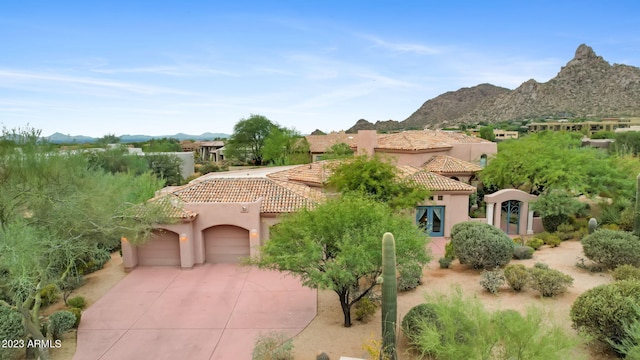 view of front of home with a mountain view and a garage