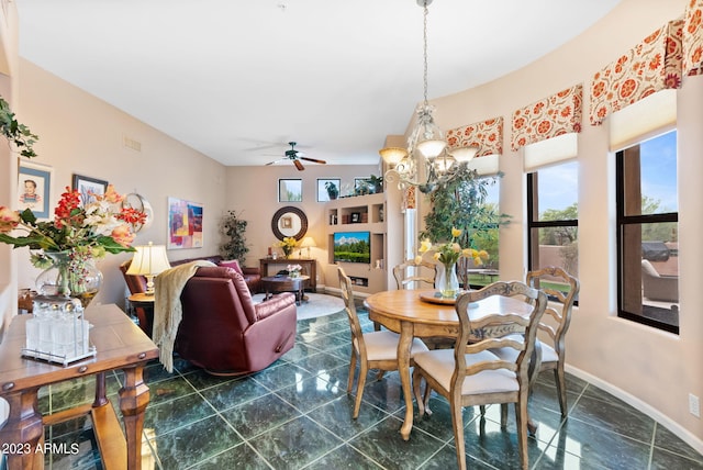 dining space featuring ceiling fan with notable chandelier