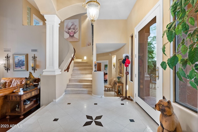 tiled foyer featuring decorative columns