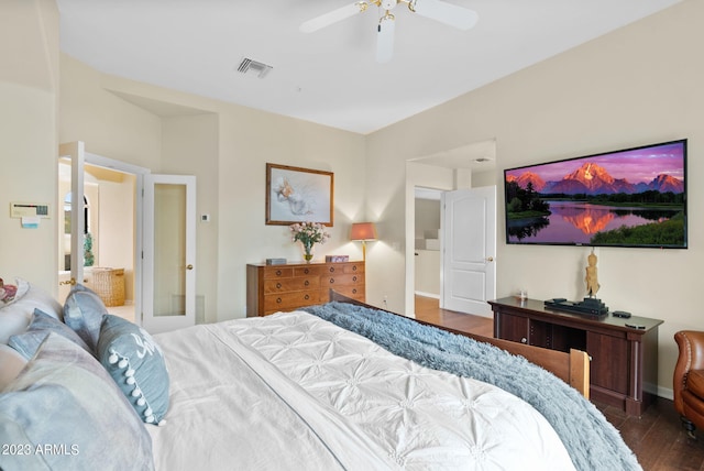 bedroom featuring dark hardwood / wood-style flooring, ceiling fan, and ensuite bathroom