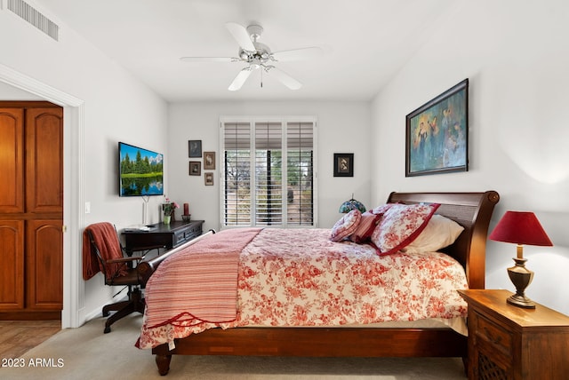 bedroom with ceiling fan and light carpet