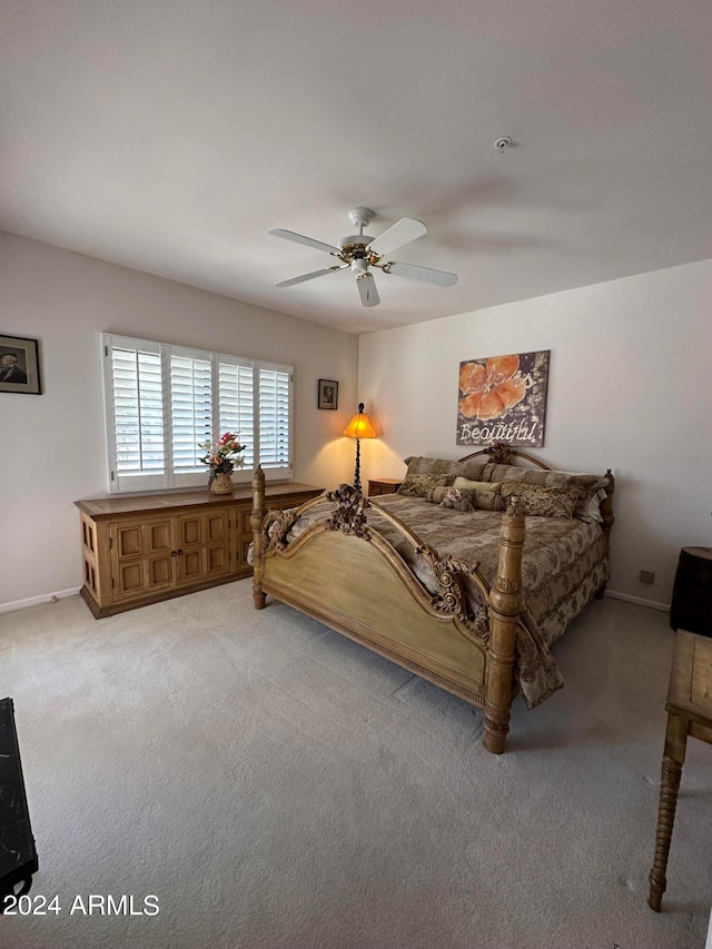 bedroom featuring ceiling fan and light colored carpet